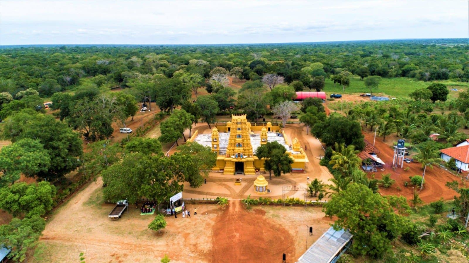 Daytime aerial view of the temple surrounded by trees