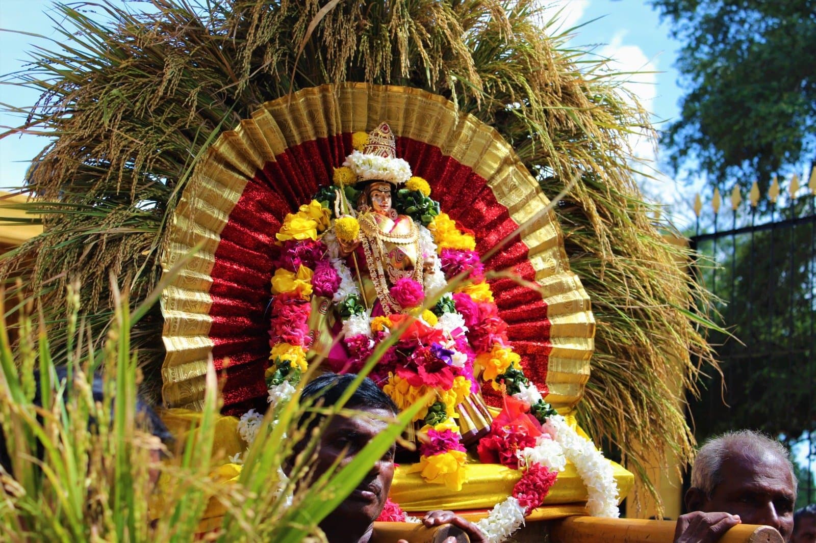 Festival idol seated on a floral throne during the annual Pongal Vizha procession