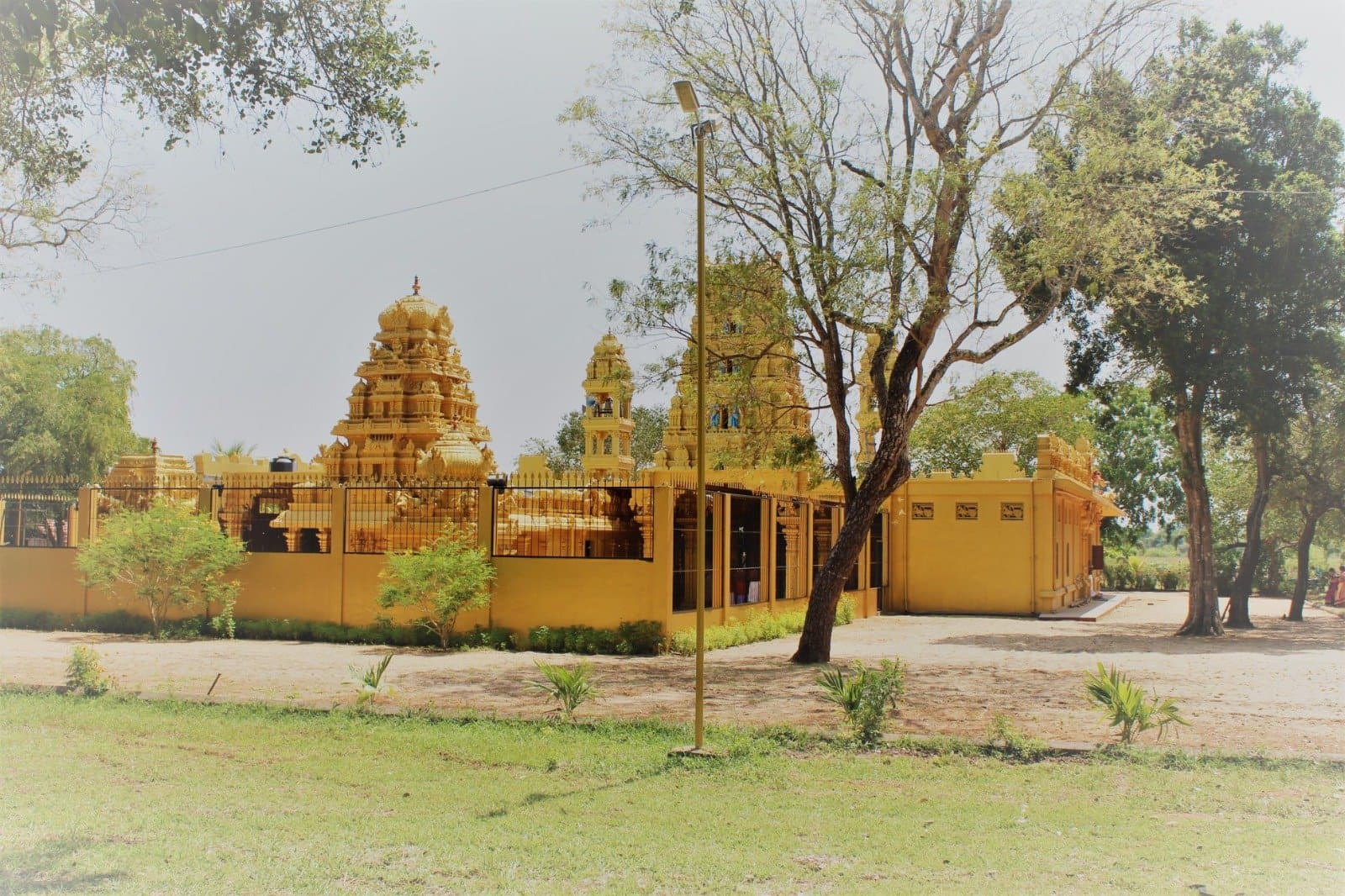 Side view of the temple compound with surrounding trees