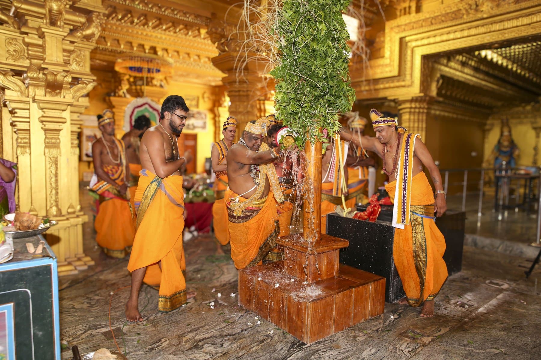 Vedic priests performing the kodietram ceremony at the sacred sthambam inside the golden mandapam